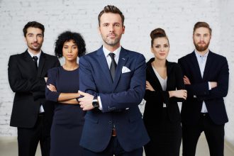 Group of perky lawyers, businesspeople standing together